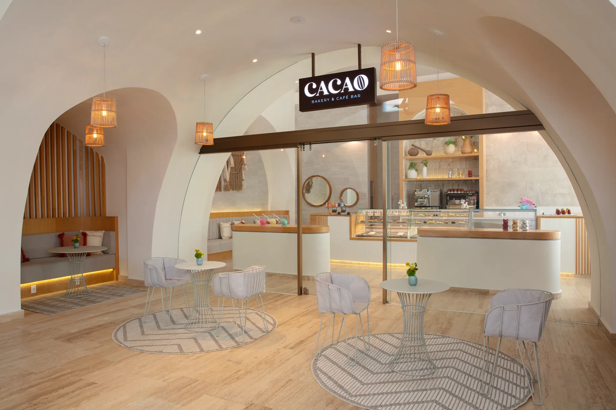 Cacao café at Impression Isla Mujeres by Secrets featuring a chic coffee shop setting with artisanal desserts, pastries, and modern décor.