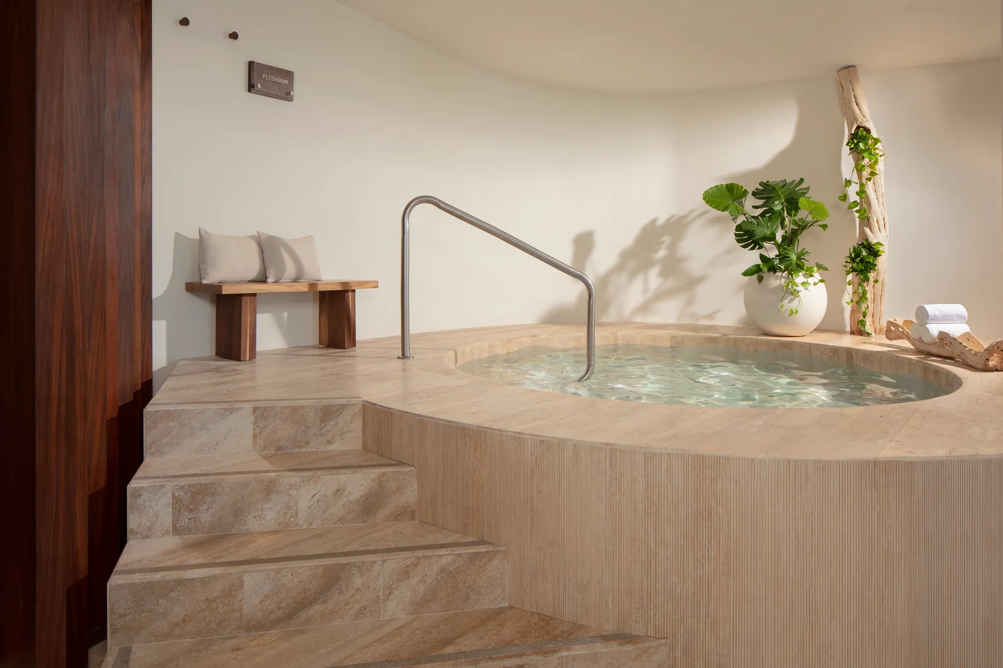 Indoor flotarium spa pool with steps and calming neutral design at Impression Isla Mujeres by Secrets.