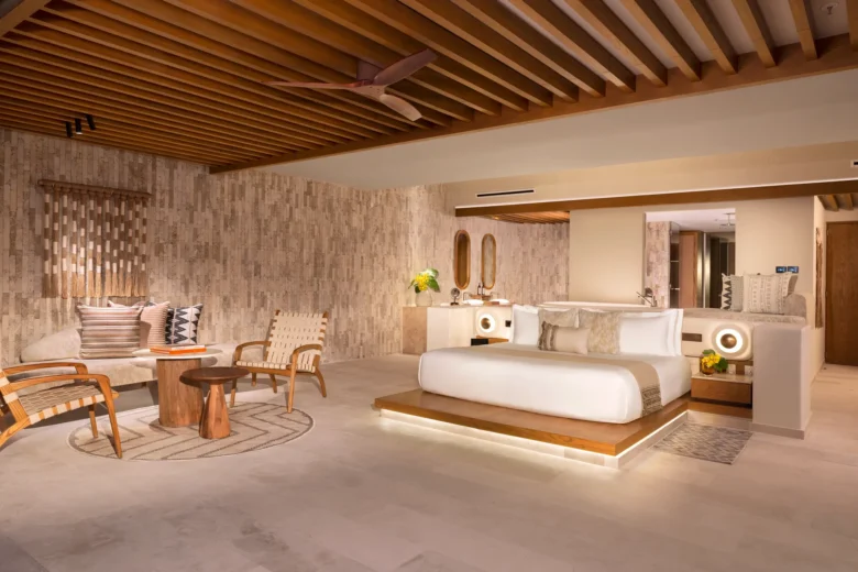 Honeymoon Ocean Front suite bedroom with king bed and ocean views at Impression Isla Mujeres by Secrets.