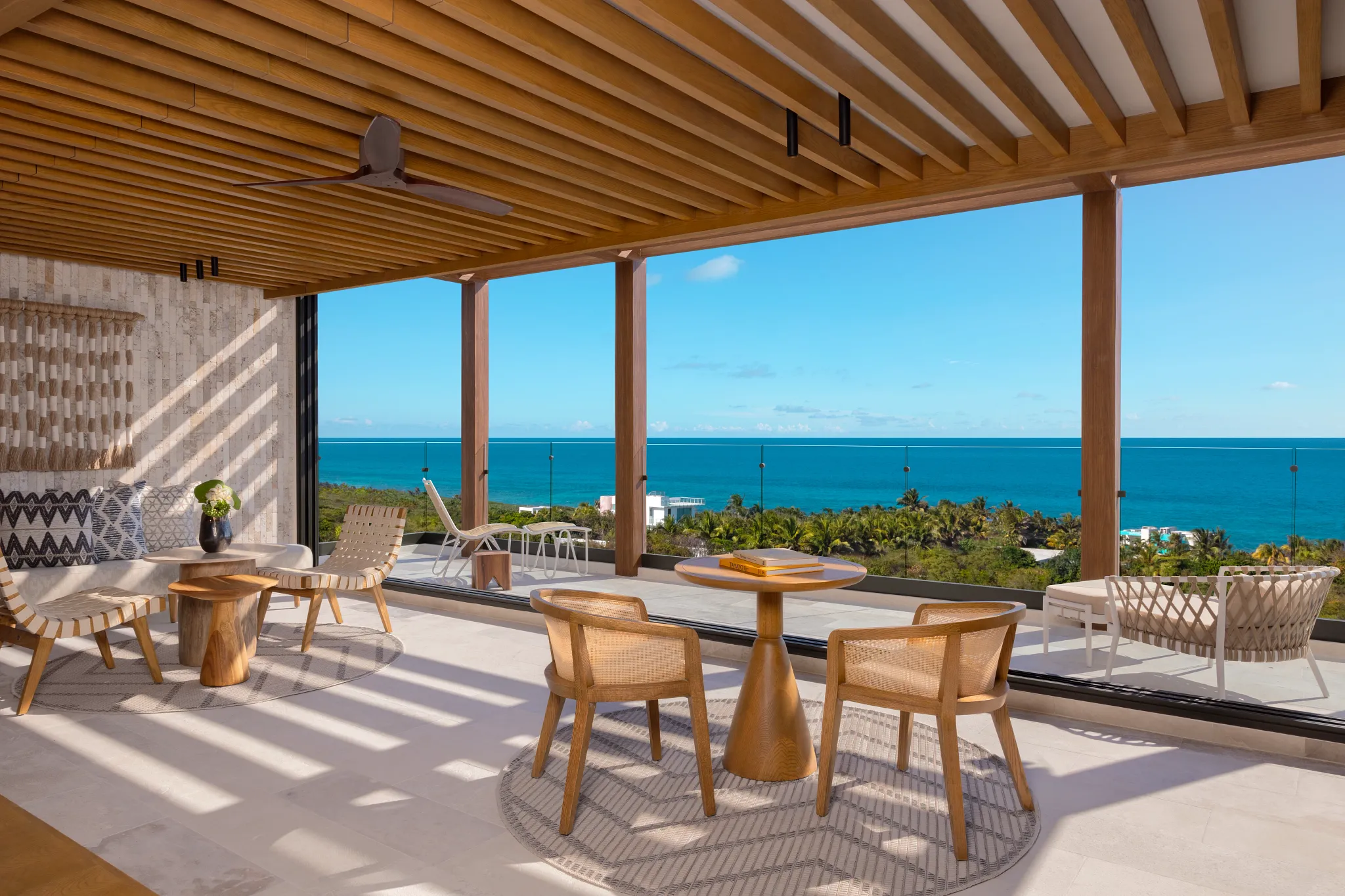 Oversized private terrace with seating and ocean views in Honeymoon Ocean View suite at Impression Isla Mujeres by Secrets.