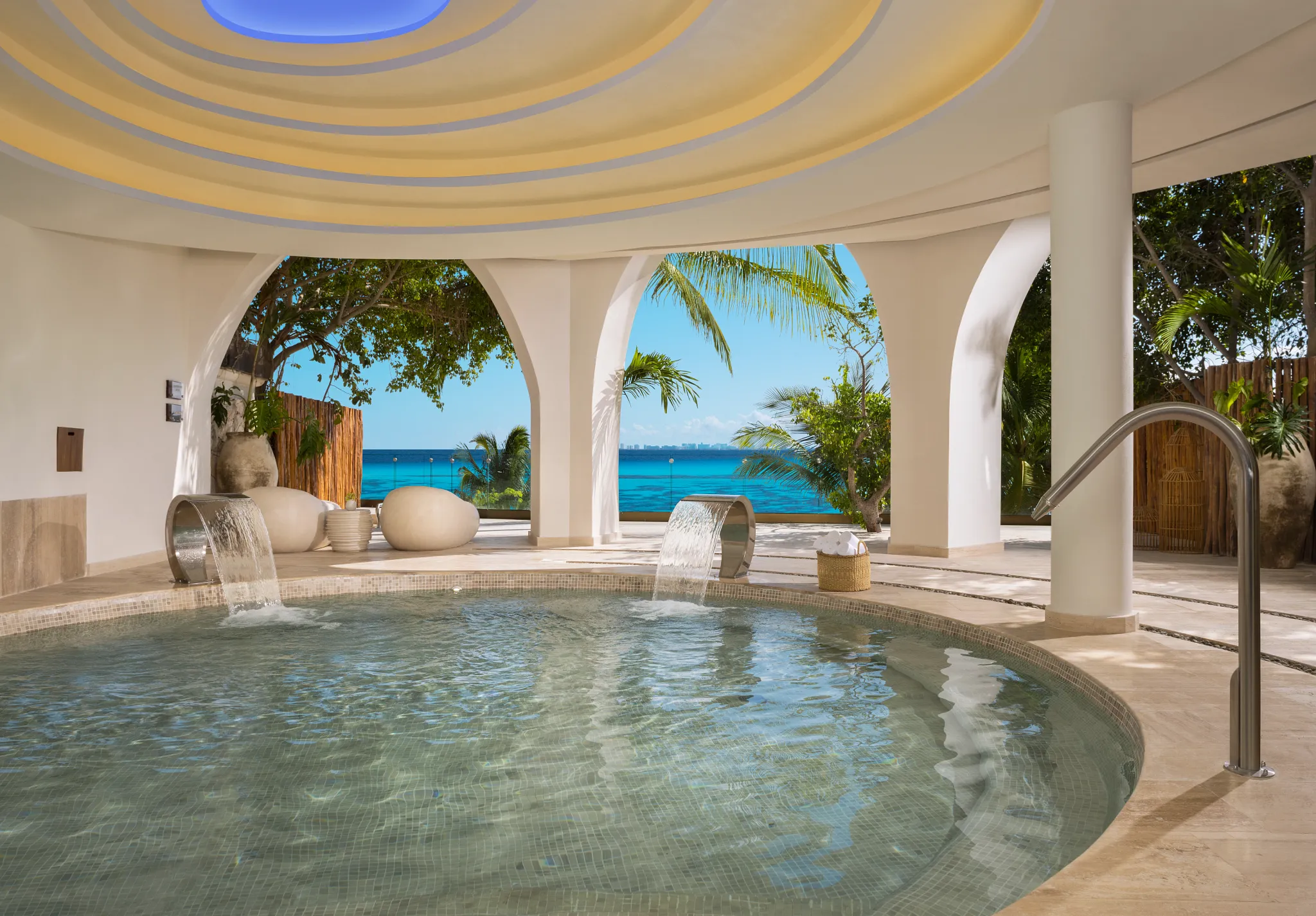 Hydrotherapy pool with water features and ocean view arches at Impression Isla Mujeres by Secrets.