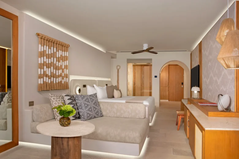 Junior Suite King bedroom with king bed and modern décor at Impression Isla Mujeres by Secrets.