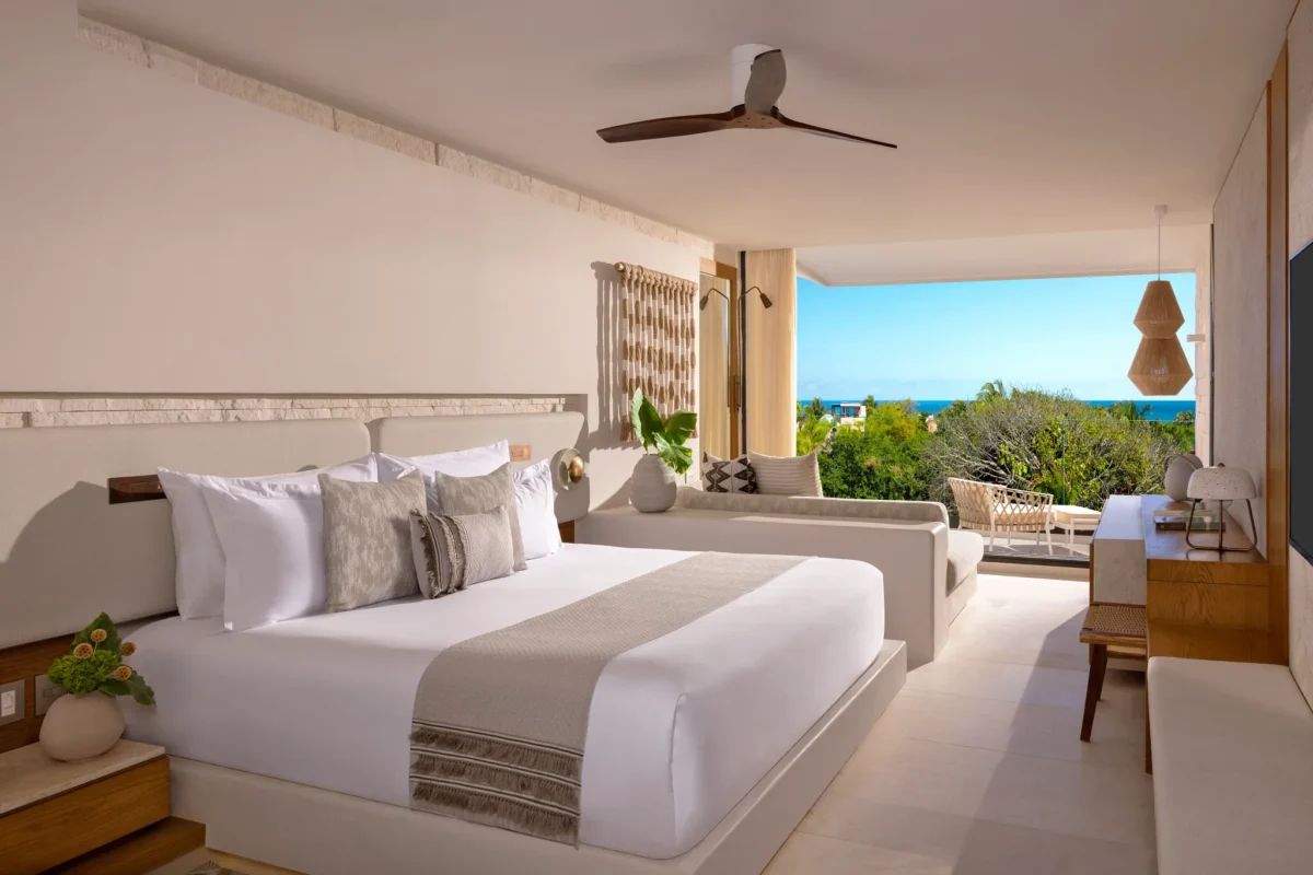 Junior Suite King Partial Ocean View with king bed and modern décor at Impression Isla Mujeres by Secrets.