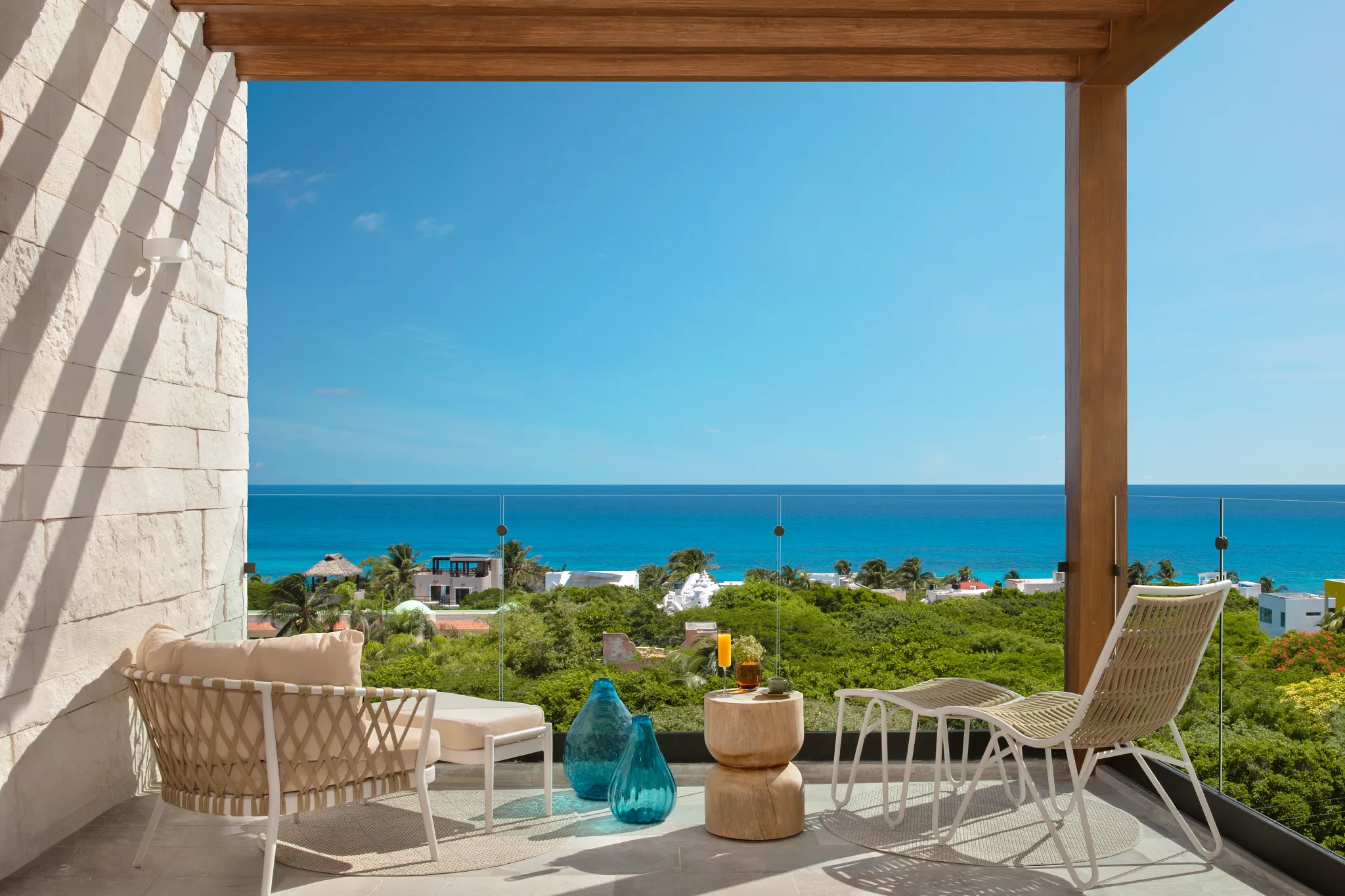 Junior Suite King Partial Ocean View terrace with lounge seating and ocean views at Impression Isla Mujeres by Secrets.