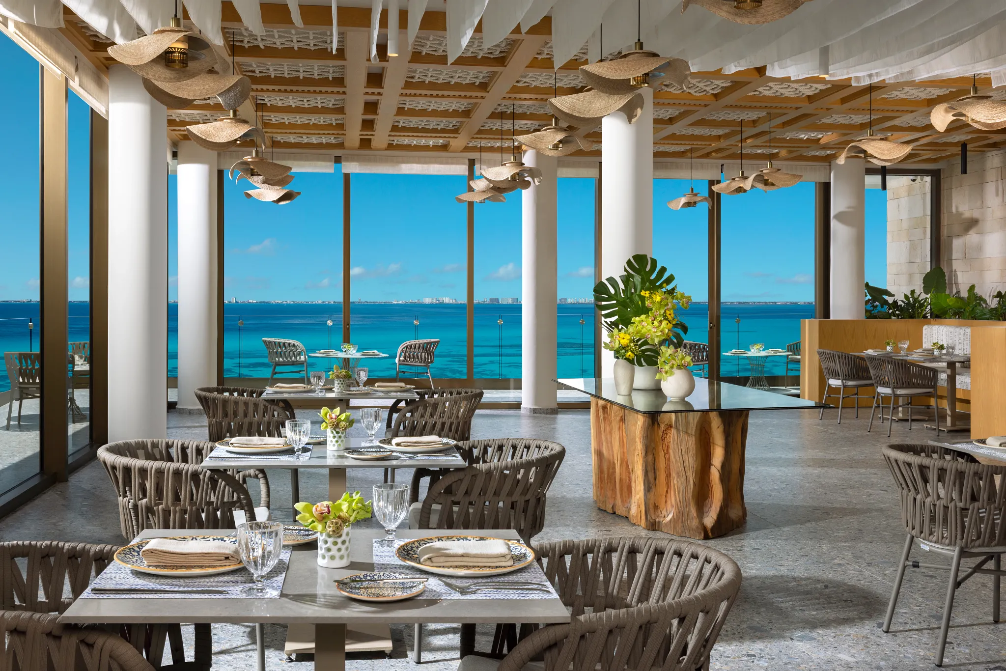 La Vista restaurant at Impression Isla Mujeres by Secrets featuring an elegant terrace dining space with panoramic ocean views and refined ambiance.
