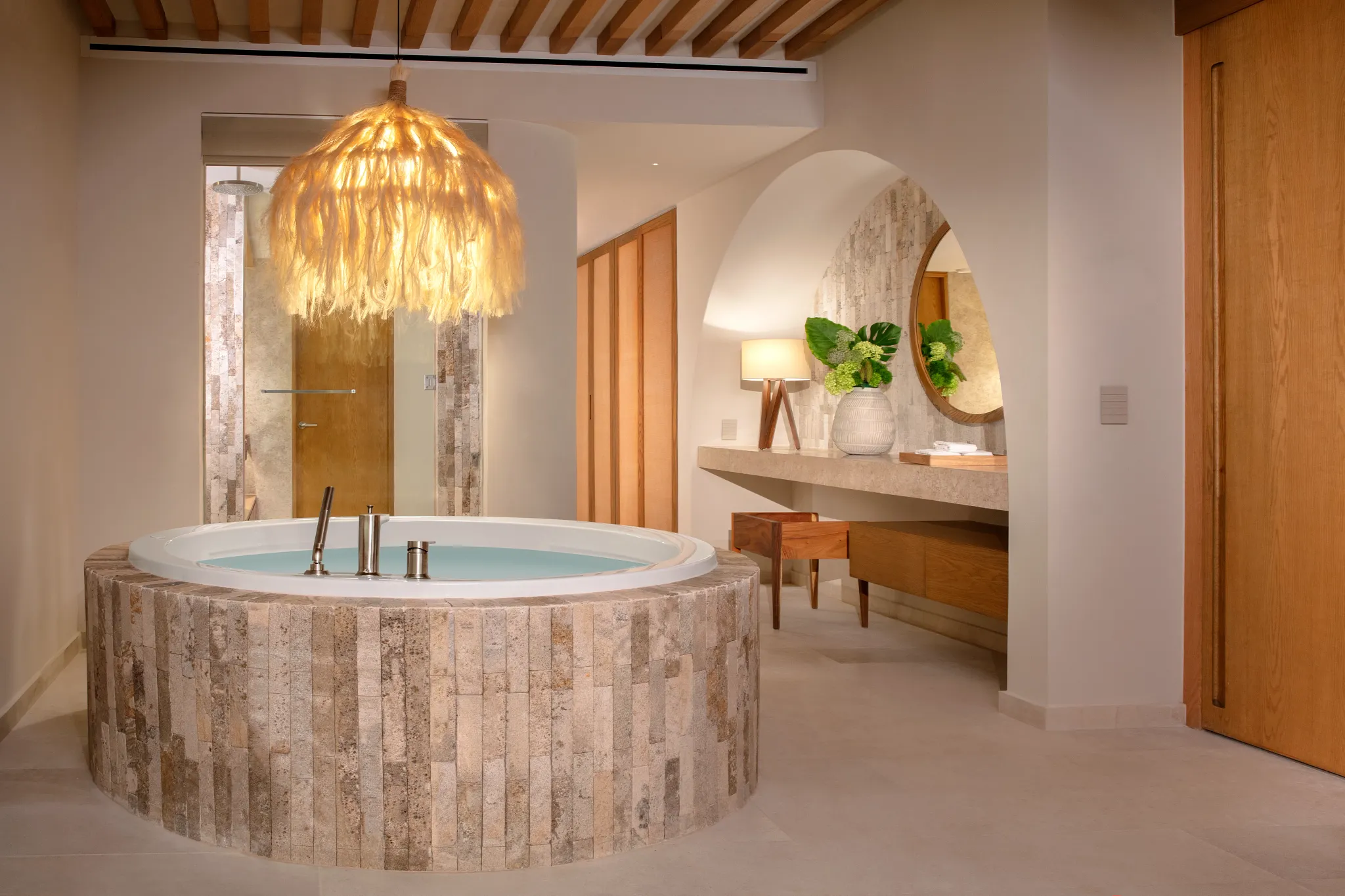 Indoor soaking tub under decorative lighting in Presidential Suite at Impression Isla Mujeres by Secrets.