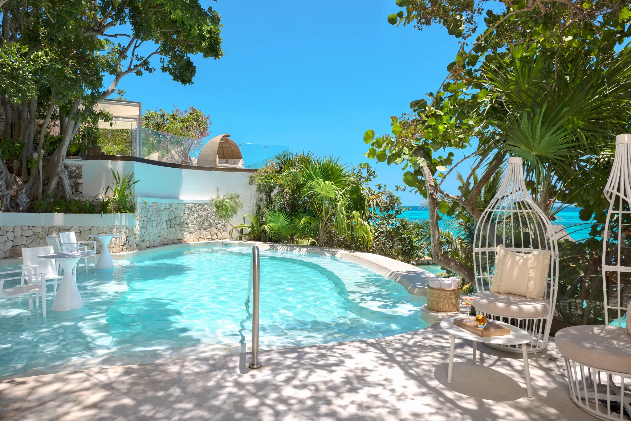 Private outdoor whirlpool pool area surrounded by lush greenery at Impression Isla Mujeres by Secrets.