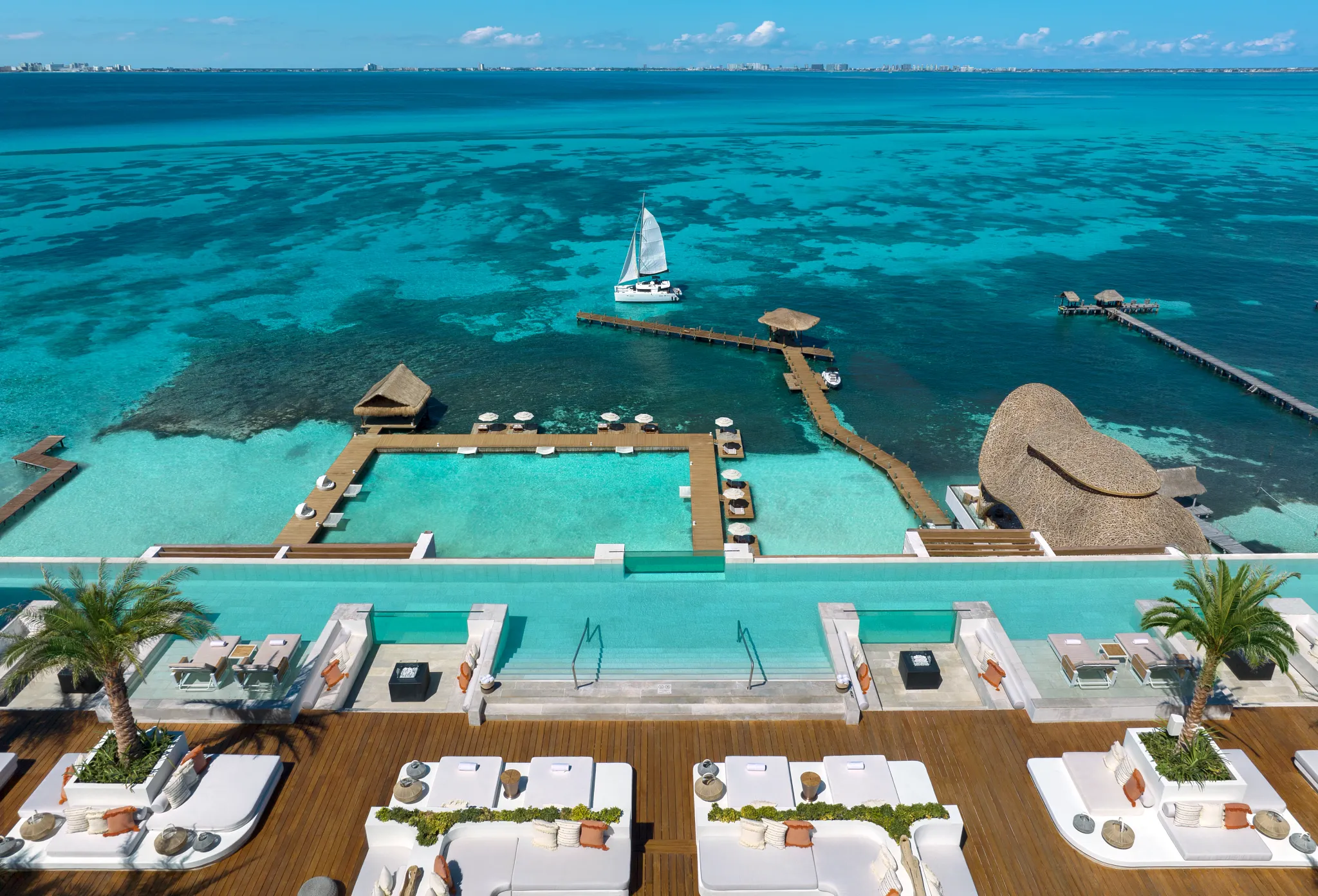 Rooftop infinity pool and ocean view terraces at Impression Isla Mujeres by Secrets with Caribbean horizon.