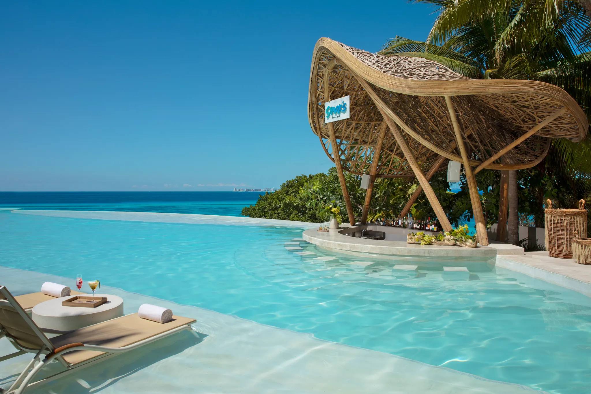 Sharks restaurant at Impression Isla Mujeres by Secrets featuring an elegant oceanfront dining space with modern design and coastal views.
