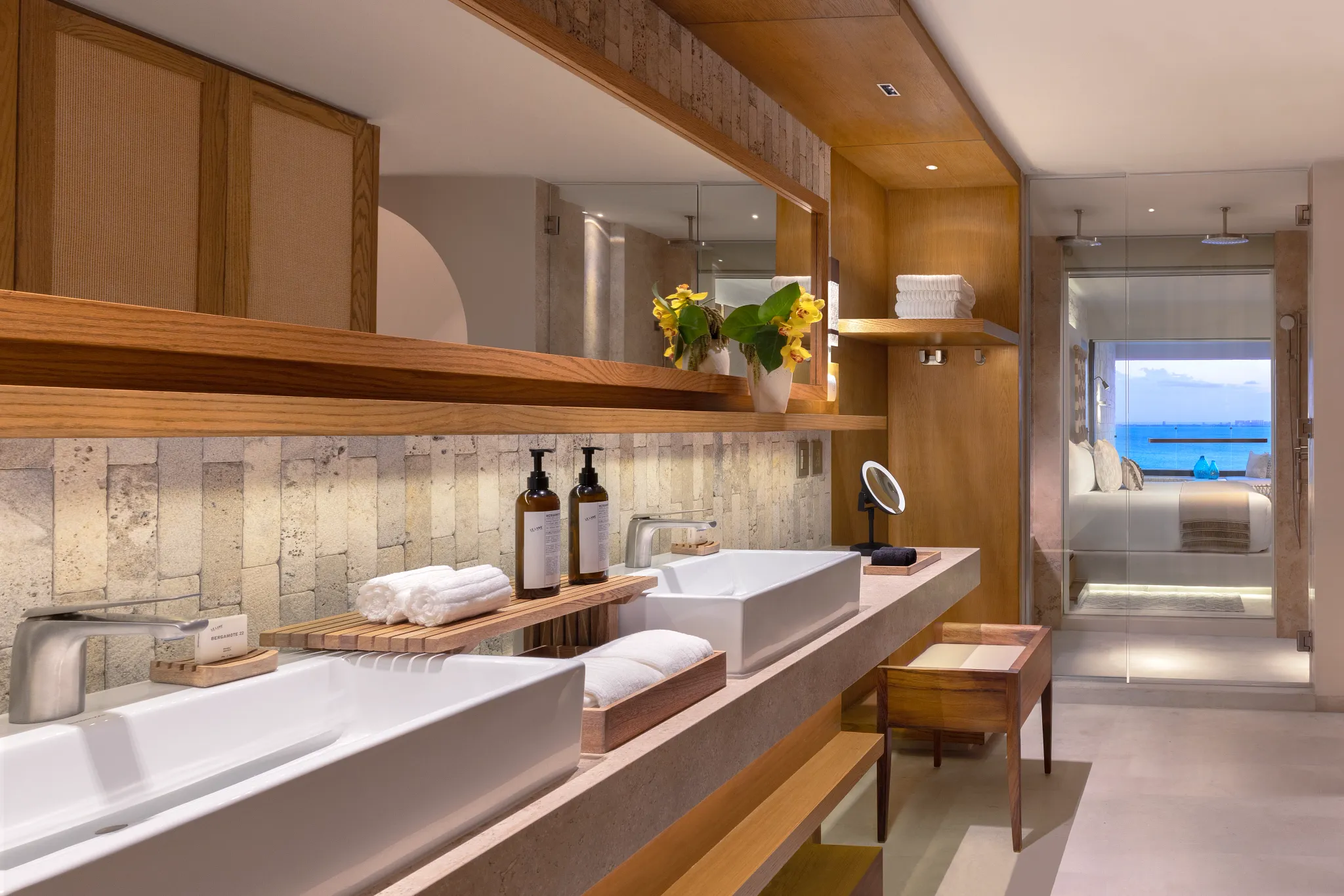 Modern bathroom with dual sinks, rainfall shower, and luxury finishes in Signature Junior Suite at Impression Isla Mujeres by Secrets.