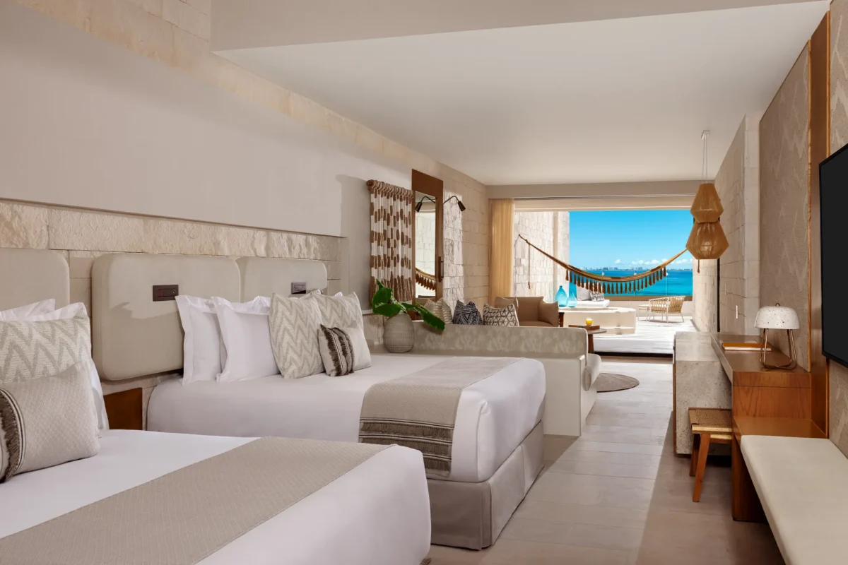 Signature Junior Suite Double Ocean Front with two queen beds and ocean view at Impression Isla Mujeres by Secrets.