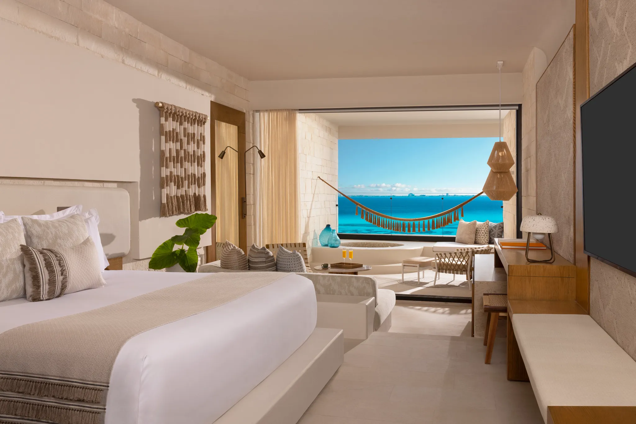Signature Junior Suite King Ocean Front bedroom with ocean view and private terrace at Impression Isla Mujeres by Secrets.