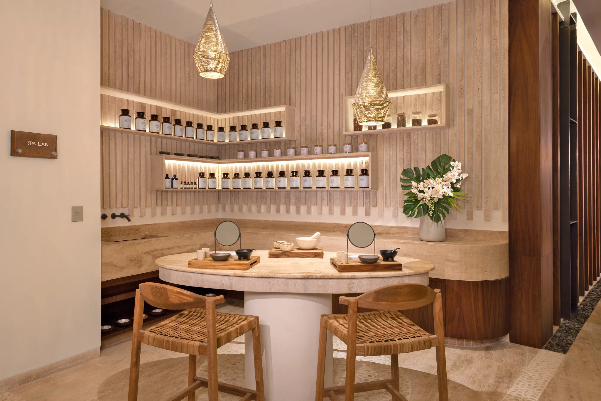 Spa lab with skincare products displayed on shelves and treatment stations at Impression Isla Mujeres by Secrets.