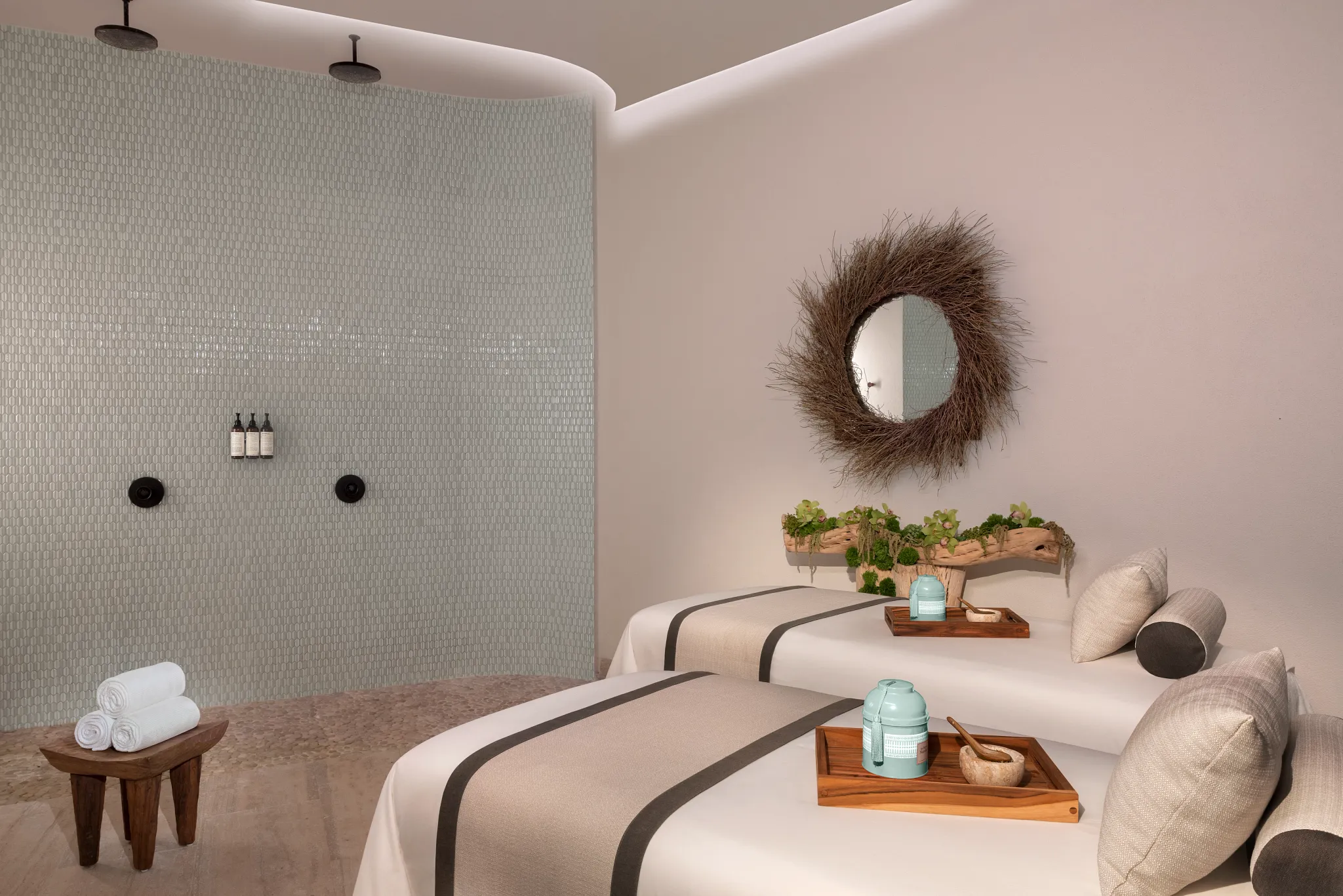 Spa treatment room with dual massage beds and walk-in shower at Impression Isla Mujeres by Secrets.