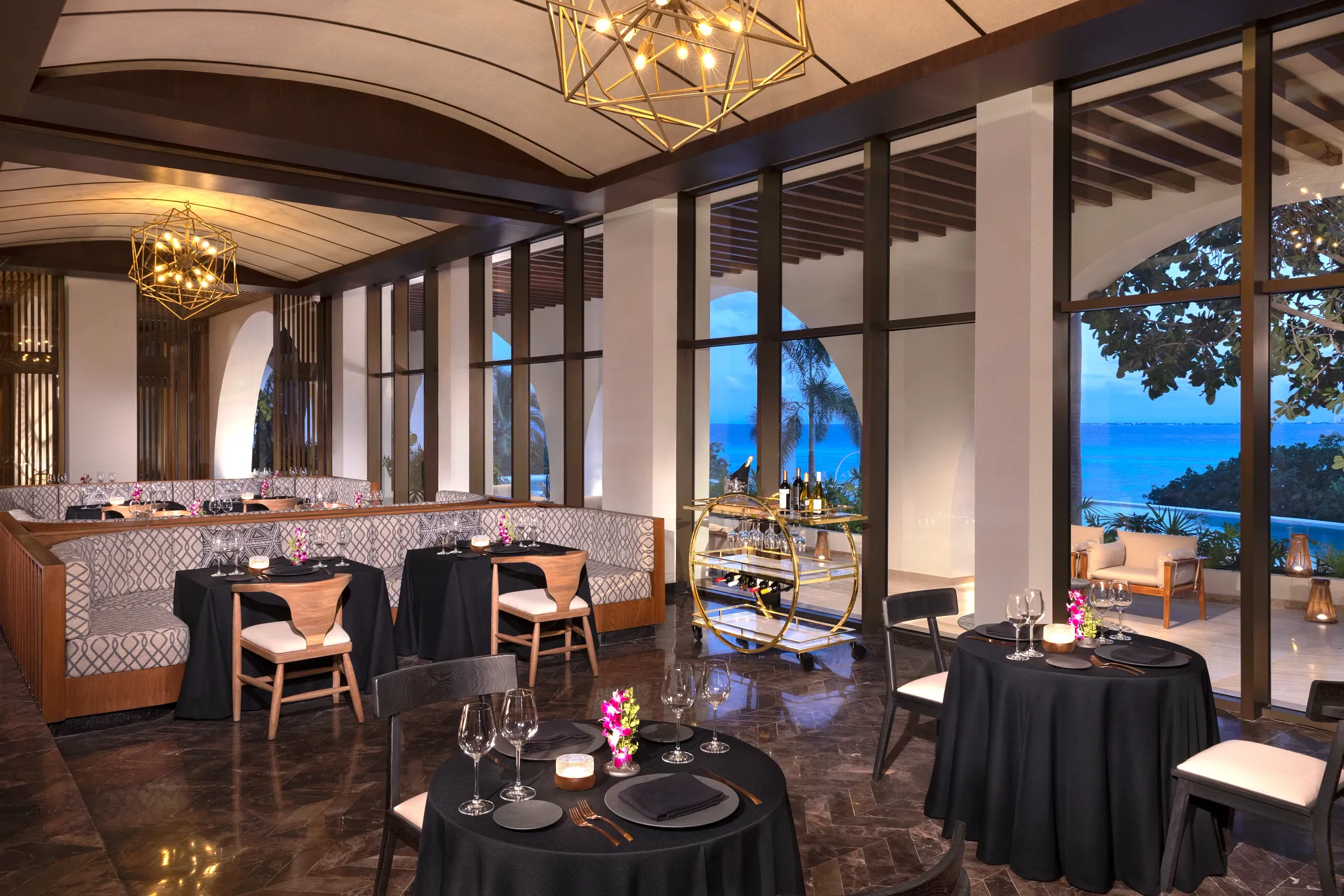 Wildfire Grill at Impression Isla Mujeres by Secrets featuring an upscale open-air steakhouse, wood-fired cooking, and elegant evening ambiance.