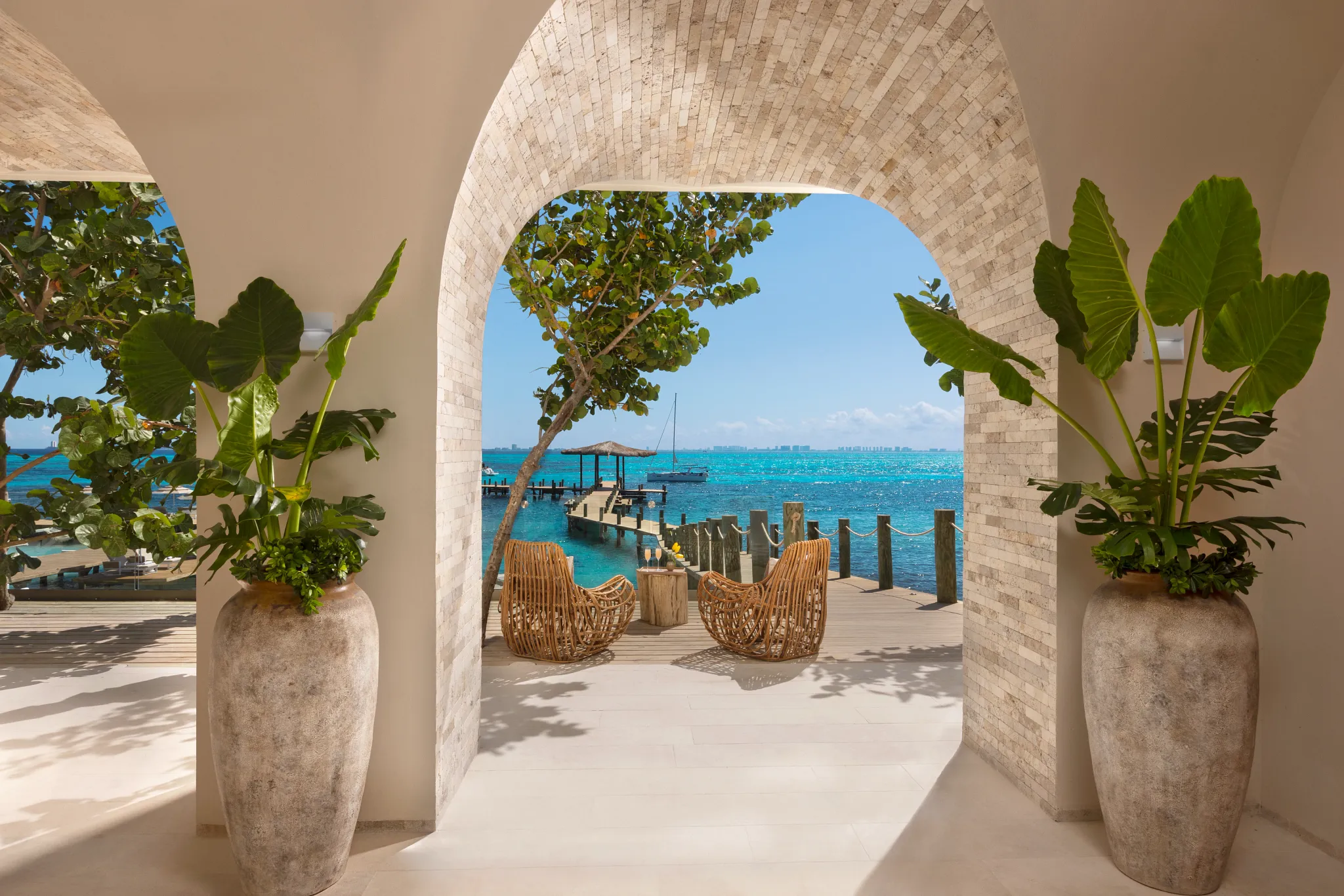 Yacht Welcome Lounge at Impression Isla Mujeres by Secrets featuring an elegant marina-side arrival space with luxury seating and ocean views.